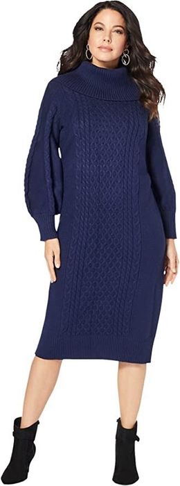 The model is wearing a navy dress, completed with black boots.