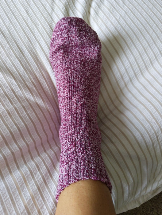 Reviewer sporting a pair of purple marled socks