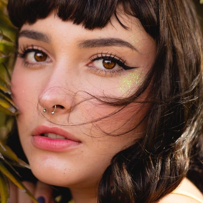 A model sporting glitter along their cheekbones