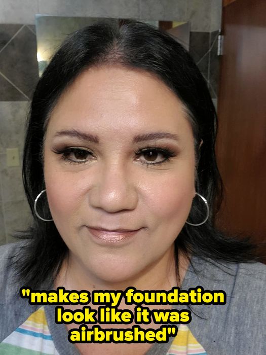 A reviewer with makeup applied, showcasing text that reads
