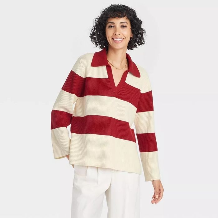 Model sporting a red and white striped top with white pants.