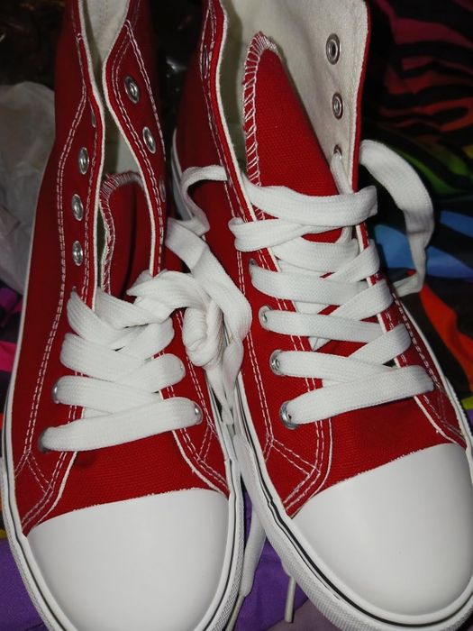 A pair of high-top sneakers featuring white laces and accents, perfect for casual wear.