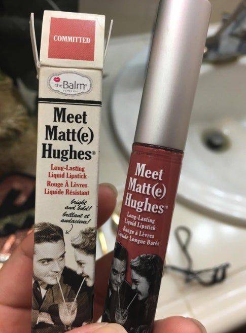 The image features a hand holding a box and a tube of