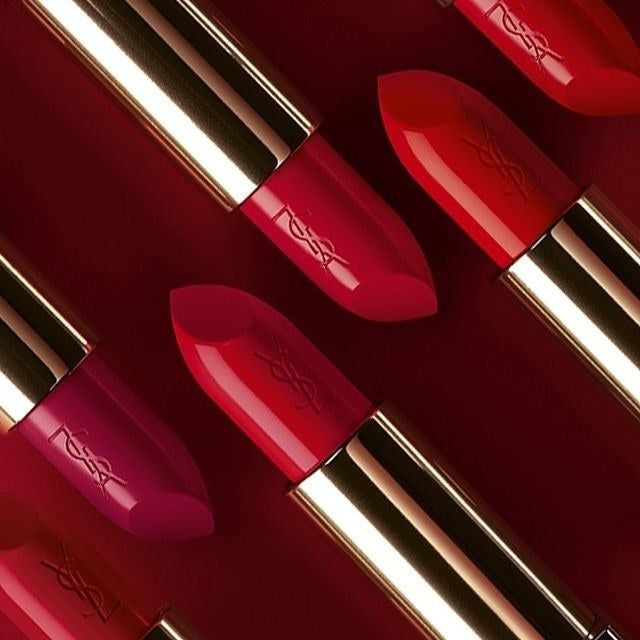 A selection of red lipsticks adorned with the iconic YSL logo.