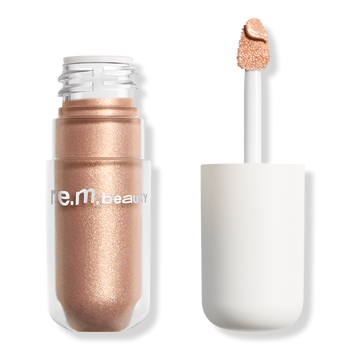 A shimmering bronze liquid eyeshadow in a bottle with an applicator, labeled