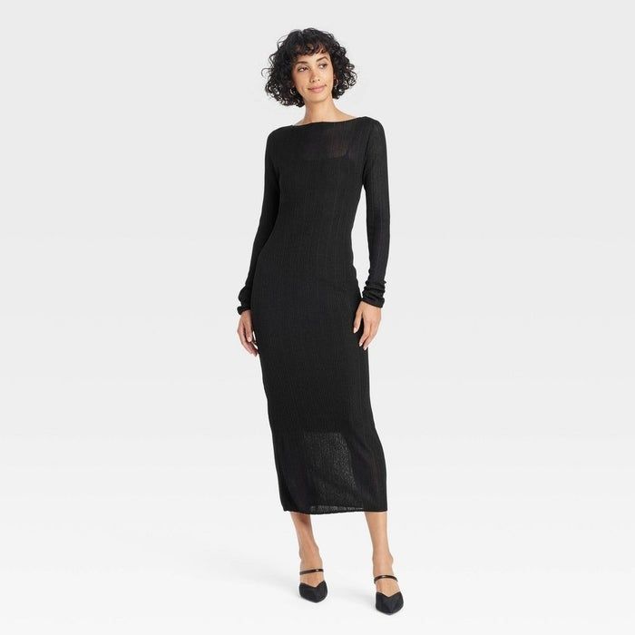 Model wearing a slightly sheer black long-sleeved sweater midi dress