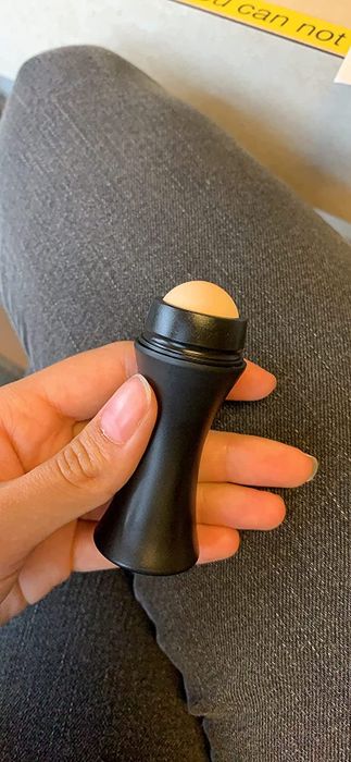 Photo of the reviewer showing the face roller.