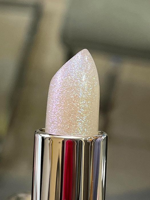 A close-up view of a shimmering lip balm