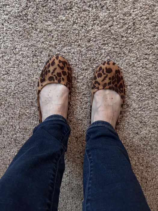A reviewer rocking animal print flats.