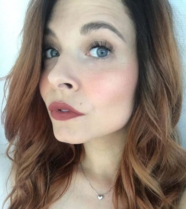 A reviewer sporting the Canyon shade of lipstick