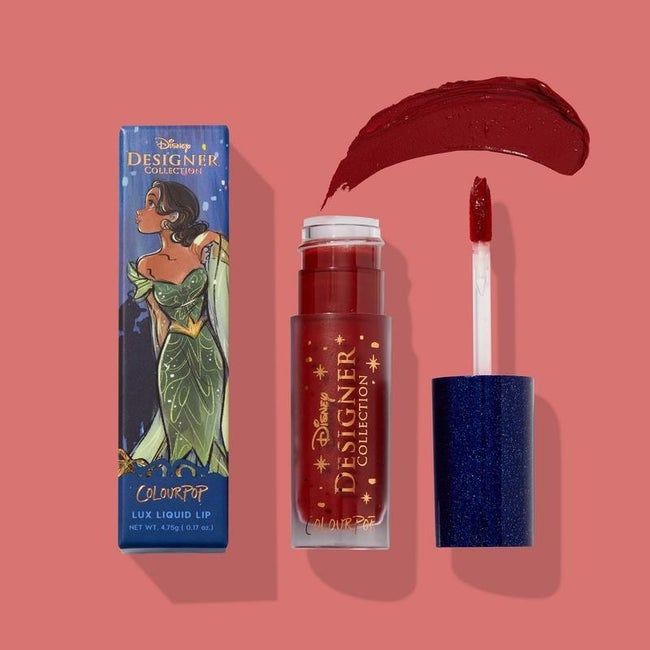 A red lipstick featuring an elegant illustration of Tiana on the packaging.