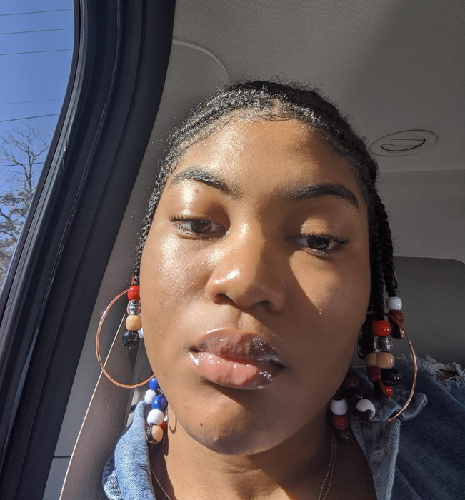 Close-up selfie of a reviewer showing off their clear complexion.