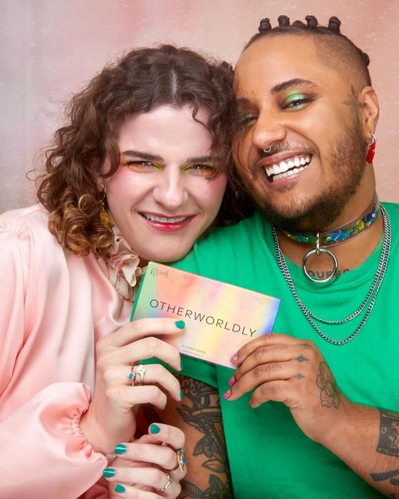 Two models proudly showcasing the makeup palette.