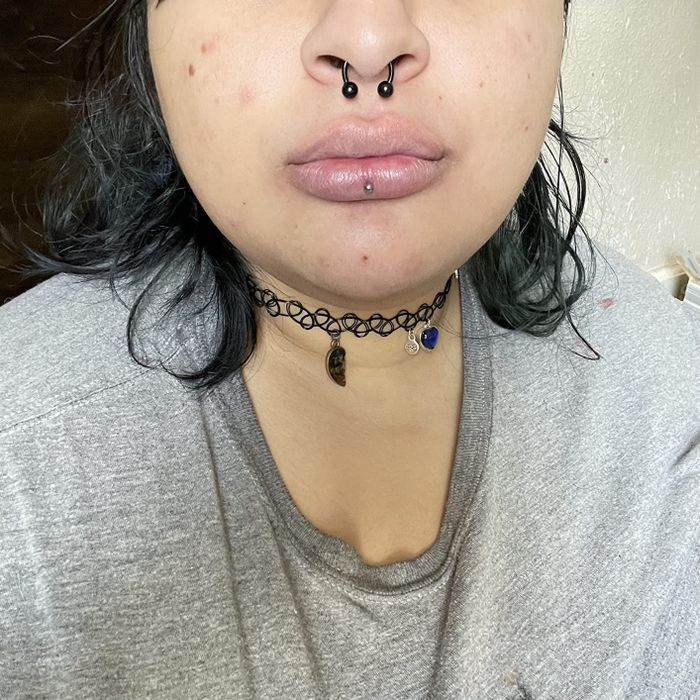 A reviewer before applying the tinted lip butter