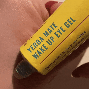 GIF demonstrating the application of yerba mate eye cream on the back of a hand.