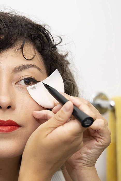 A model using the eye makeup shield to create a flawless winged eyeliner look.