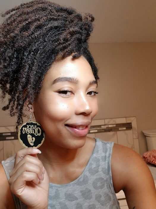 A reviewer showcasing their glowing, highlighted skin