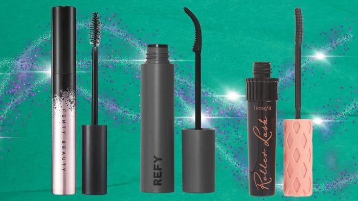 Fenty Beauty's Full Frontal Mascara, Refy Mascara, and Benefit Roller Lash Mascara are arranged upright, with the wands clearly visible against a sparkling background.