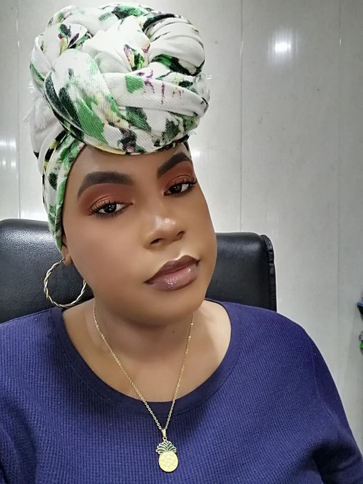 Reviewer with makeup still looking perfect hours after applying the setting spray.