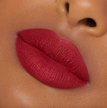 A model wearing a striking red lip.