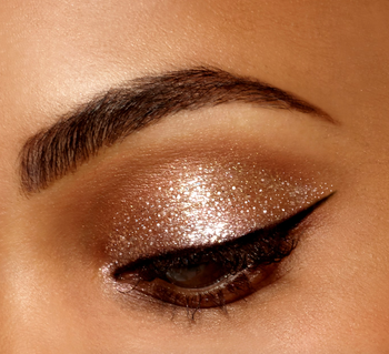 A model showcasing a glittery gold eyelid