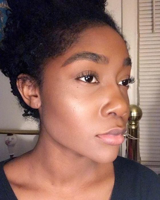 A reviewer with glowing yet matte, perfectly even skin