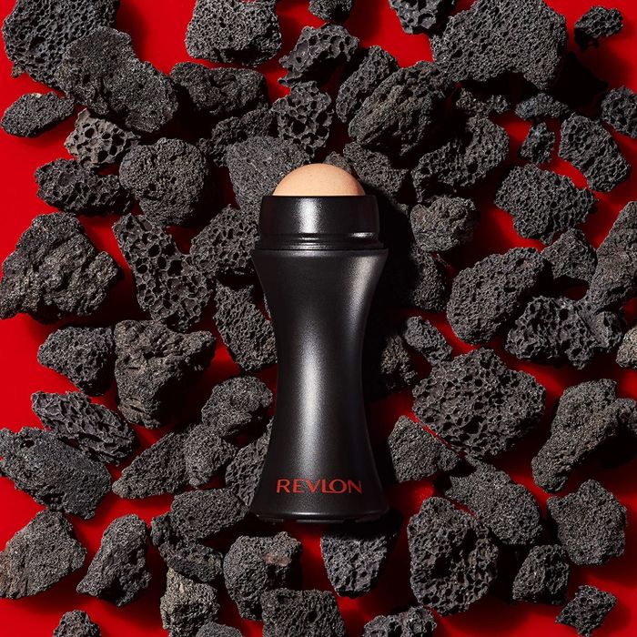 The rollerball stick resting on a bed of volcanic stones