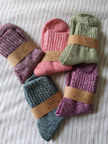 The socks available in pink, purple, green, and blue sets
