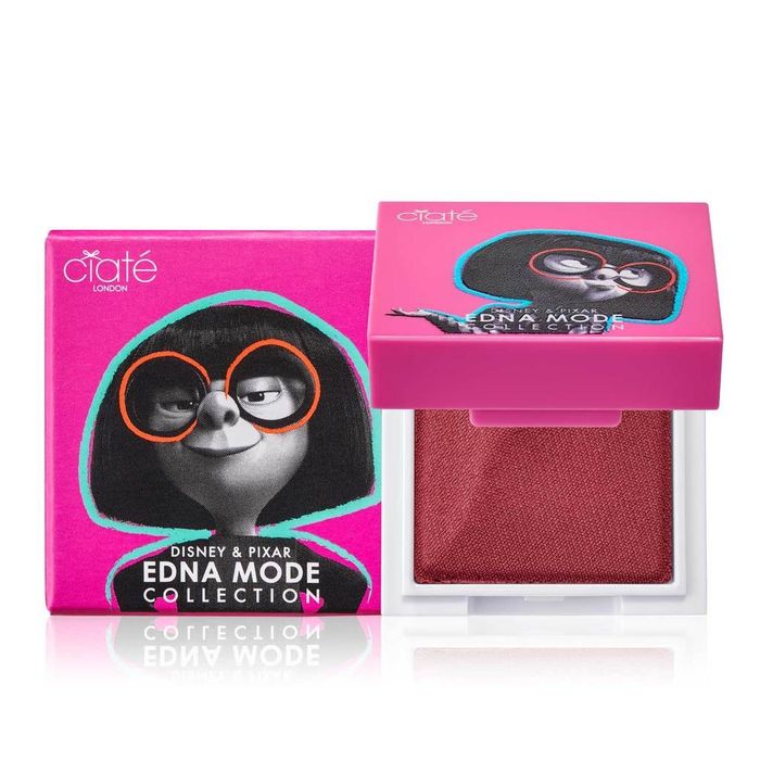 A pink square lip powder packaging featuring Edna Mode on the front.