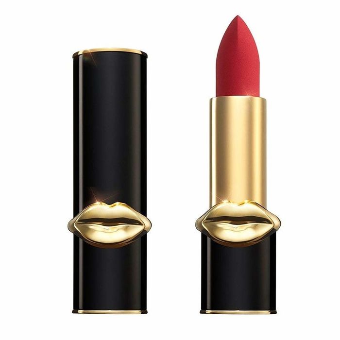 A lipstick in chic black and gold packaging with a sculpted lip design, showcasing a bold and vibrant red shade.