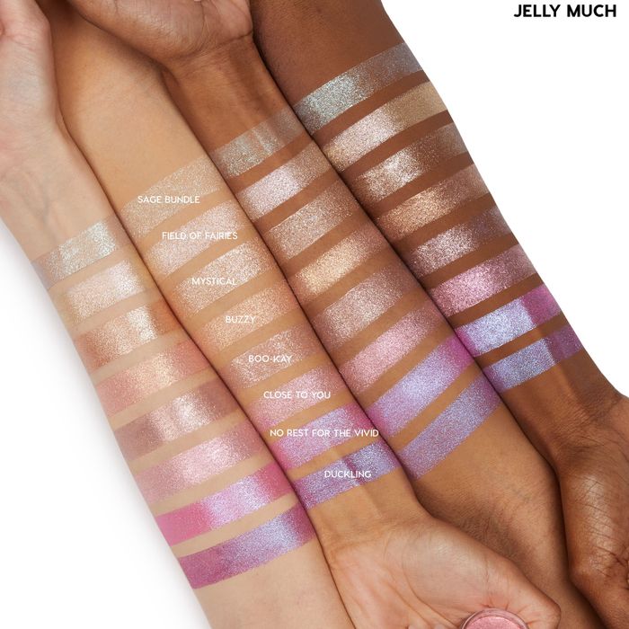 An array of glittery water-based shadows displayed on four different skin tones