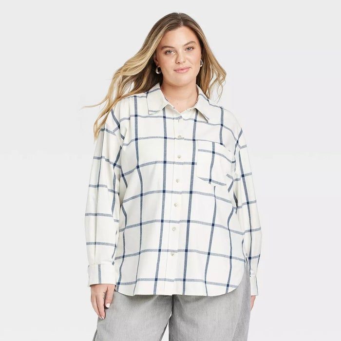 Individual in a relaxed, plaid button-down shirt and gray pants, perfect for laid-back, everyday fashion