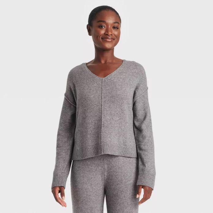 Person wearing a cozy V-neck sweater and matching knit pants, ideal for a guide on comfy loungewear for relaxed days