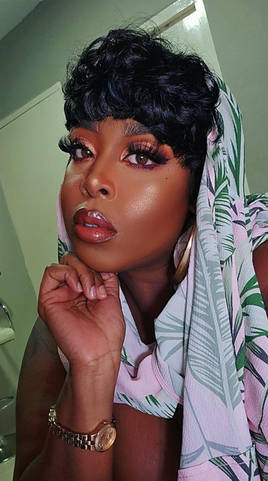 A reviewer sporting a glamorous makeup look.