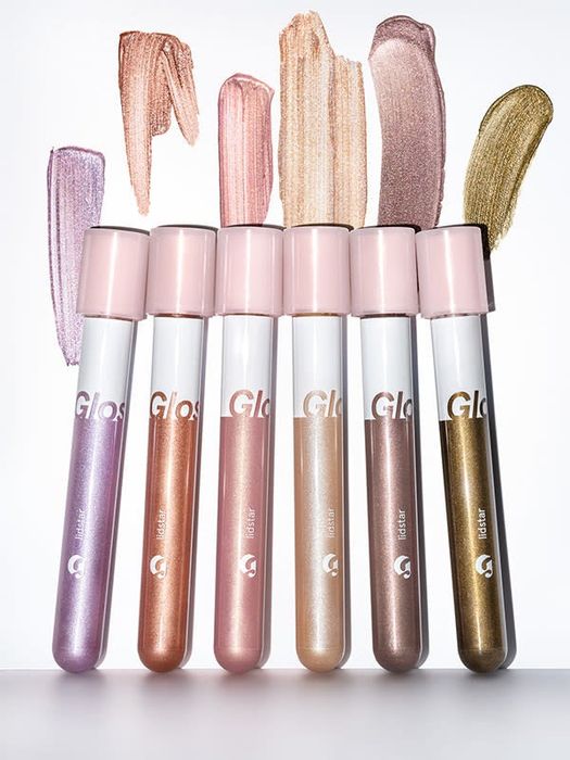 The eight shades in test tube-style packaging: lavender, peach, pink, gold, taupe, and green-gold.