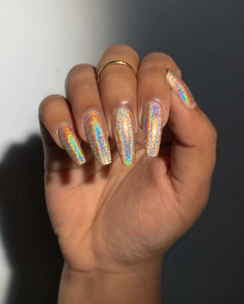 A model showcasing her holographic white nails