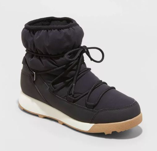 A black winter boot featuring a durable thick sole to tackle cold weather conditions
