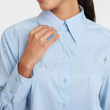 Close-up of the blue collared shirt with crystal beads