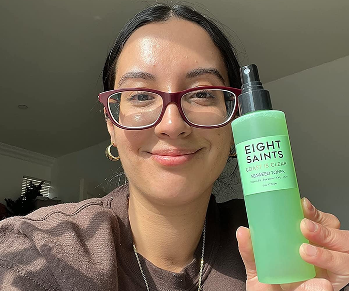 Image of a reviewer with clear skin holding the toner