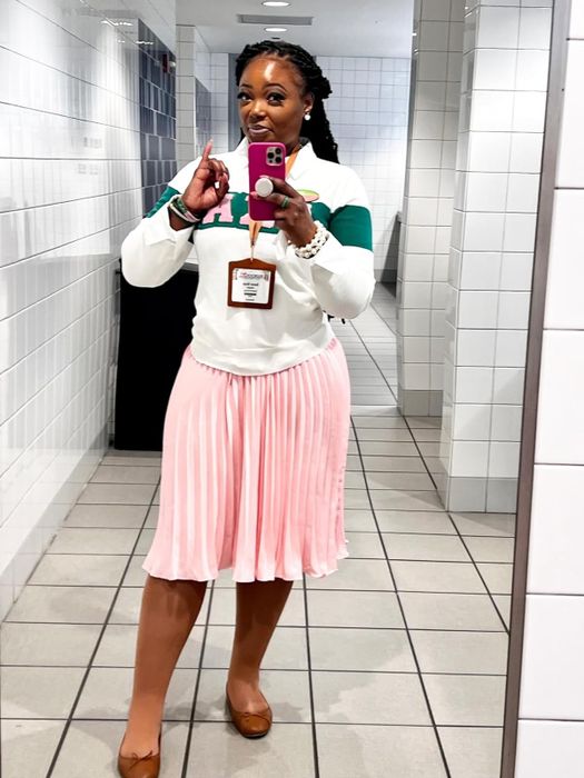 Reviewer wearing a soft pleated pink skirt.
