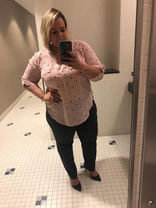 Reviewer wearing a striped blouse paired with dark pants.