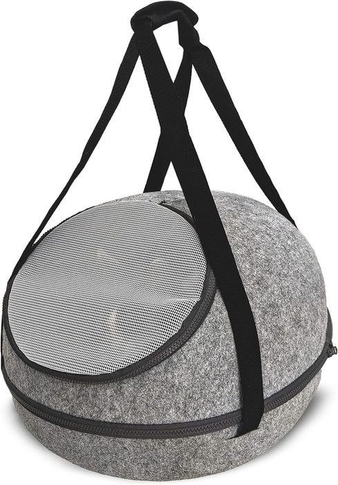 A round pet carrier with a mesh top and shoulder strap for easy carrying