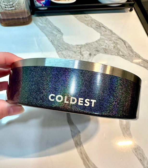 A hand gripping a sleek, black, insulated cup with a noticeable label.