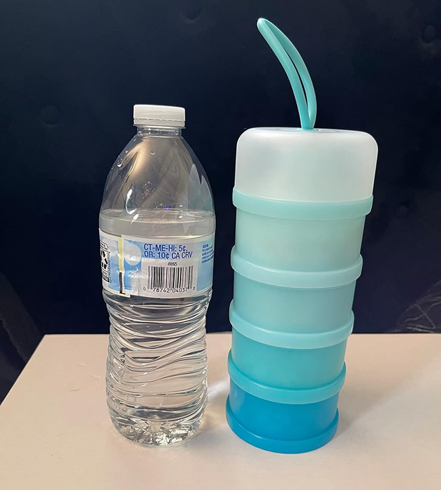 A bottle of water sits beside a tall, cylindrical blue container with a handle on top.