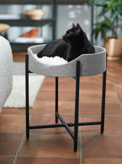 The single-tier cat tower with a black cat resting inside