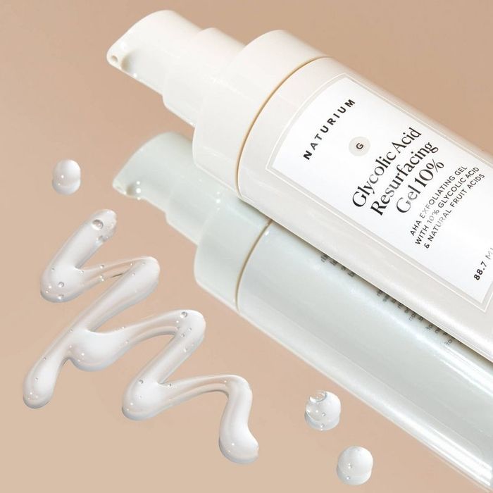 A bottle of glycolic acid gel with a swatch on a mirror surface