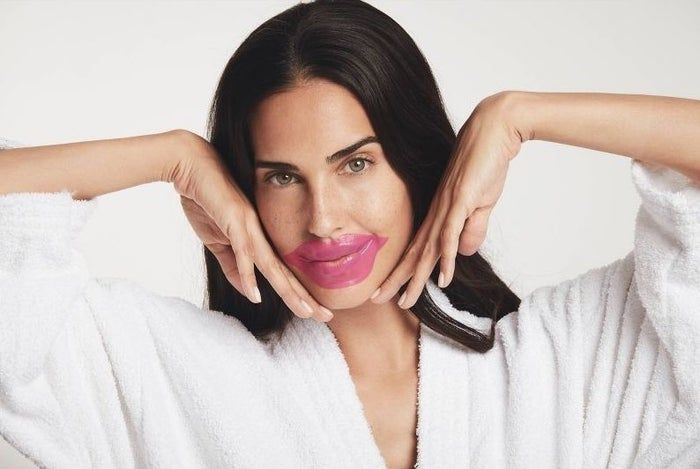 A person applying a lip mask