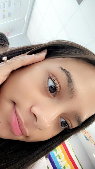 A reviewer showing off their soft, clear skin after using the serum.