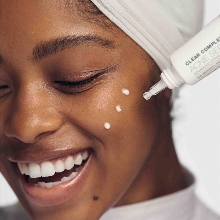 A person applying a spot treatment