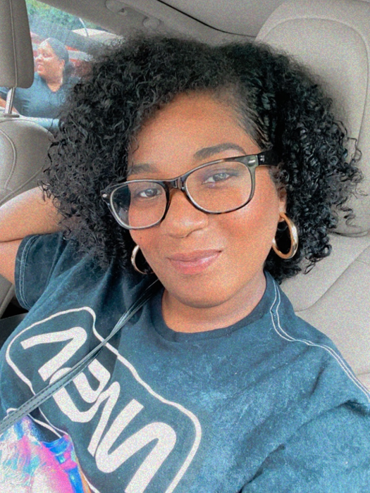 A reviewer wears the larger gold hoops with a t-shirt